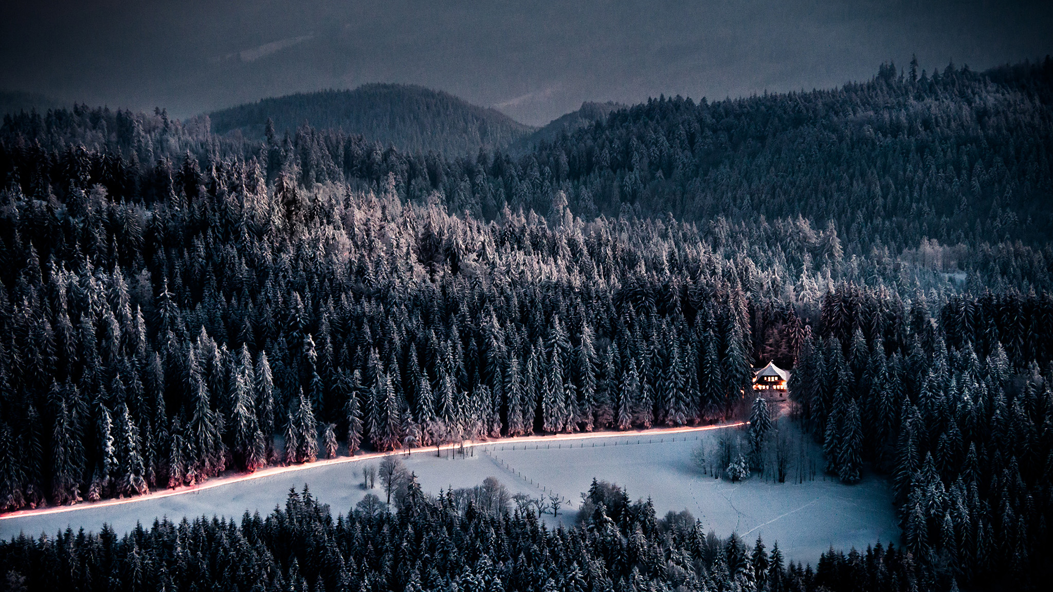 Lone Lighted Cabin in Winter Forest by Andreas Wonisch
