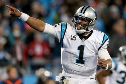 HD wallpaper of a football player in mid-action, wearing a number 1 Carolina jersey, gesturing on the field, suitable as a desktop background.