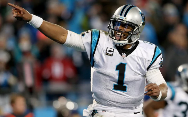 HD wallpaper of a football player in mid-action, wearing a number 1 Carolina jersey, gesturing on the field, suitable as a desktop background.