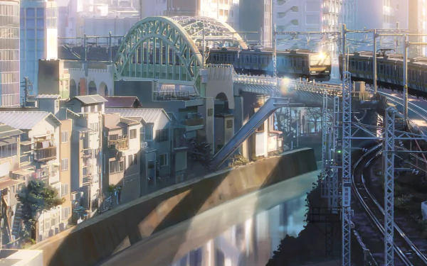 Anime-style HD PC desktop wallpaper of a detailed cityscape featuring a crossroad with a bridge, train tracks, and buildings bathed in soft sunlight.