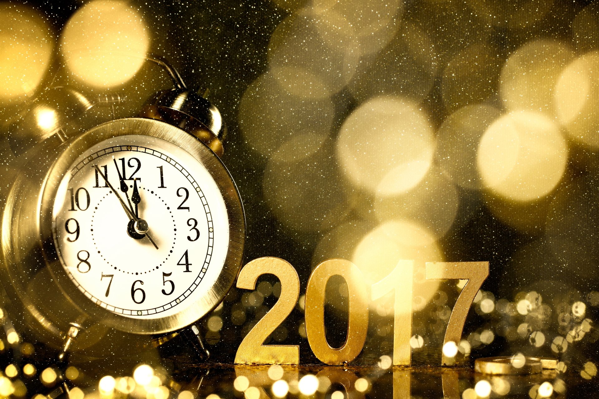 A golden clock striking midnight with bokeh lights in the background and 2017 in shimmering gold, celebrating the New Year in 8K Ultra HD resolution.
