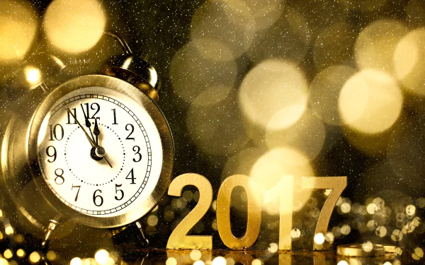 A golden clock striking midnight with bokeh lights in the background and 2017 in shimmering gold, celebrating the New Year in 8K Ultra HD resolution.