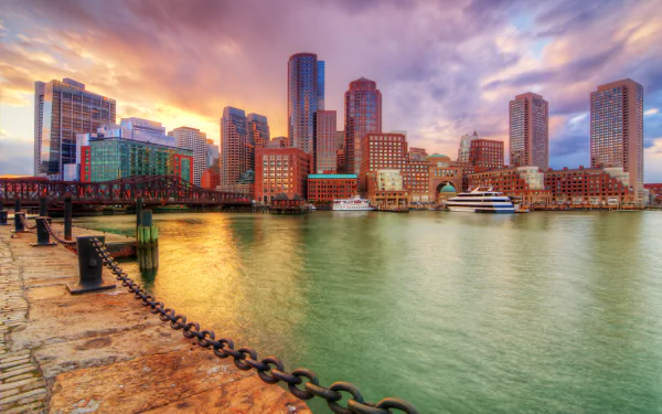 HDR 4K Ultra HD PC desktop wallpaper: Boston, Massachusetts harbor skyline with man-made waterfront, skyscrapers and boats glowing at sunset.