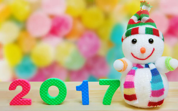 Colorful 2017 numbers with a cheerful snowman wearing a striped hat and scarf against a vibrant bokeh background, celebrating New Year 2017 in 4K Ultra HD.