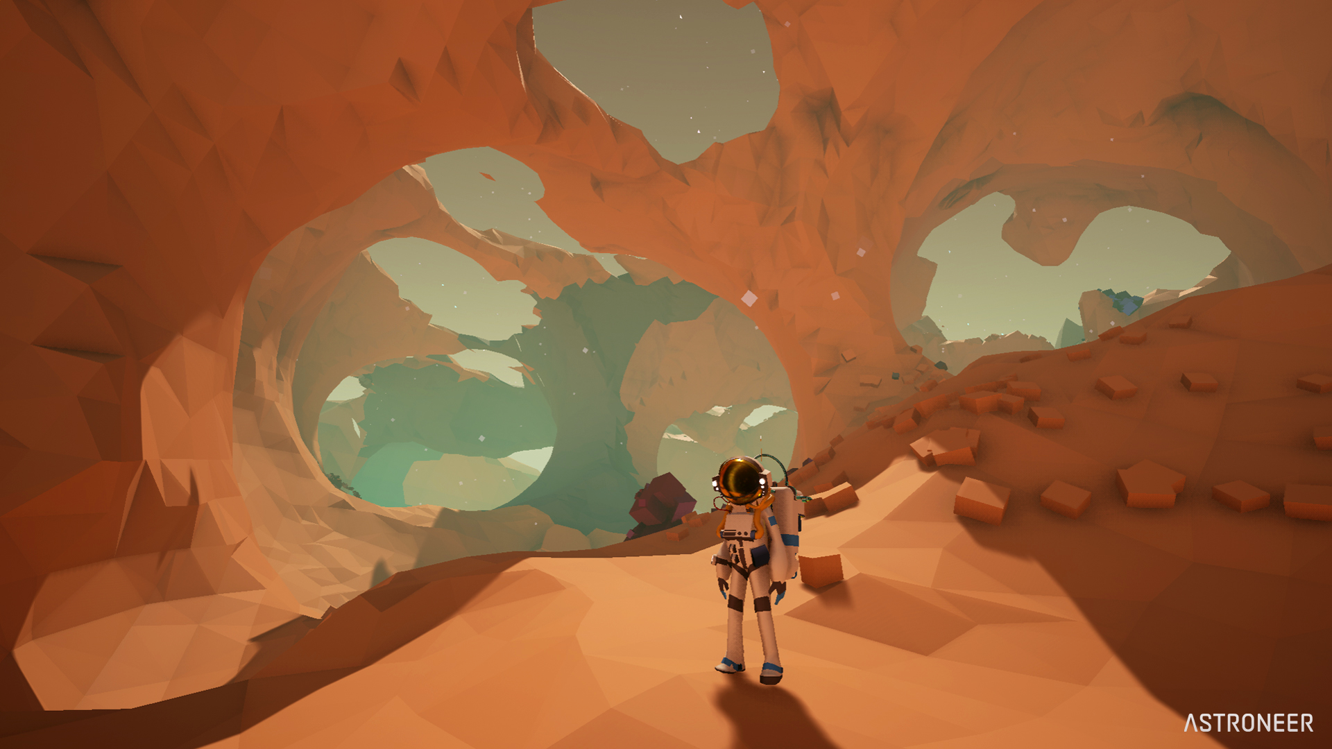 HD desktop wallpaper of an ASTRONEER character exploring a cavernous Martian landscape.