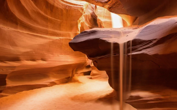A serene desert canyon path, showcasing flowing sand and dramatic rock formations, blending the beauty of nature with a barren landscape in stunning HD detail.