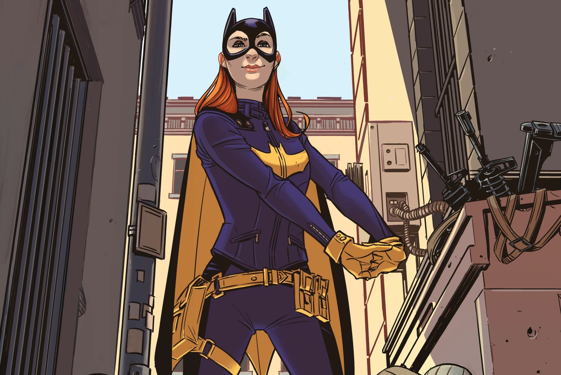 HD PC desktop wallpaper featuring a comic-style Batgirl standing confidently in an urban alley with her cape and mask in vibrant detail.