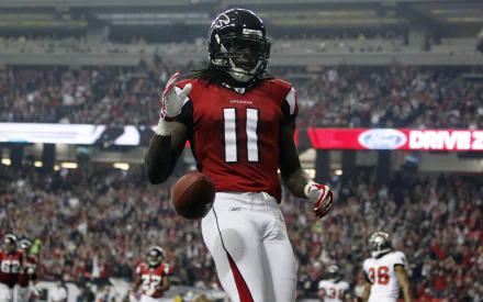 HD wallpaper featuring number 11, a football player in red and black uniform on the field during a game, creating a dynamic desktop background.