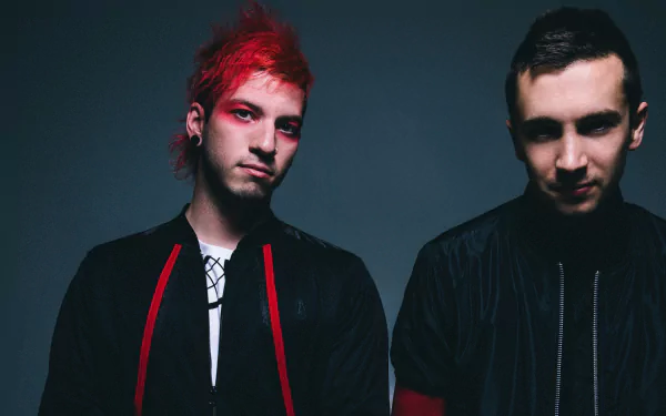 HD desktop wallpaper featuring the musical duo Twenty One Pilots, posing against a dark background.