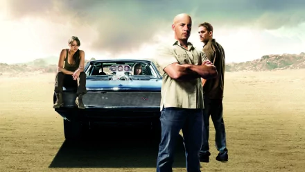 HD PC desktop wallpaper featuring main characters from the Fast & Furious movie standing in front of a classic muscle car in a desert landscape.