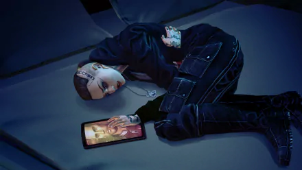HD PC desktop wallpaper featuring Jack from the video game Mass Effect, depicted lying on the floor with a tablet displaying another character's image.