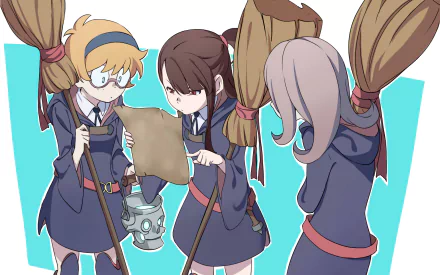A HD desktop wallpaper featuring Atsuko Kagari, Sucy Manbavaran, and Lotte Yanson from the anime Little Witch Academia. The trio is engaged in examining a map while holding their brooms.