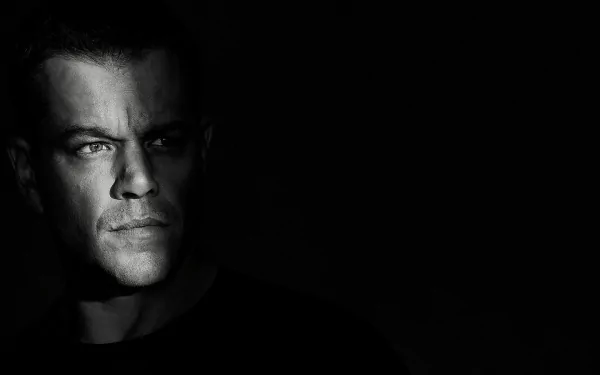 HD wallpaper of Jason Bourne movie, featuring a close-up of a man's face in dramatic lighting, against a dark background.