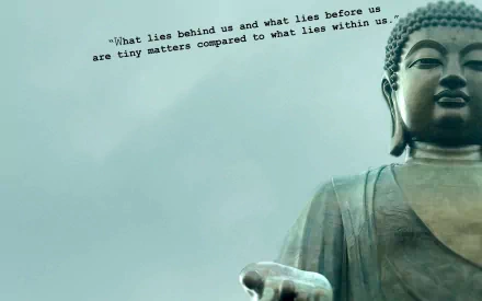 HD desktop wallpaper featuring a serene Buddha statue with a quote: What lies behind us and what lies before us are tiny matters compared to what lies within us. Buddhism, religious imagery.