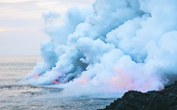 4K Ultra HD wallpaper showcasing lava flowing into the ocean in Hawaii, creating thick smoke against the natural backdrop of a volcanic coastline.