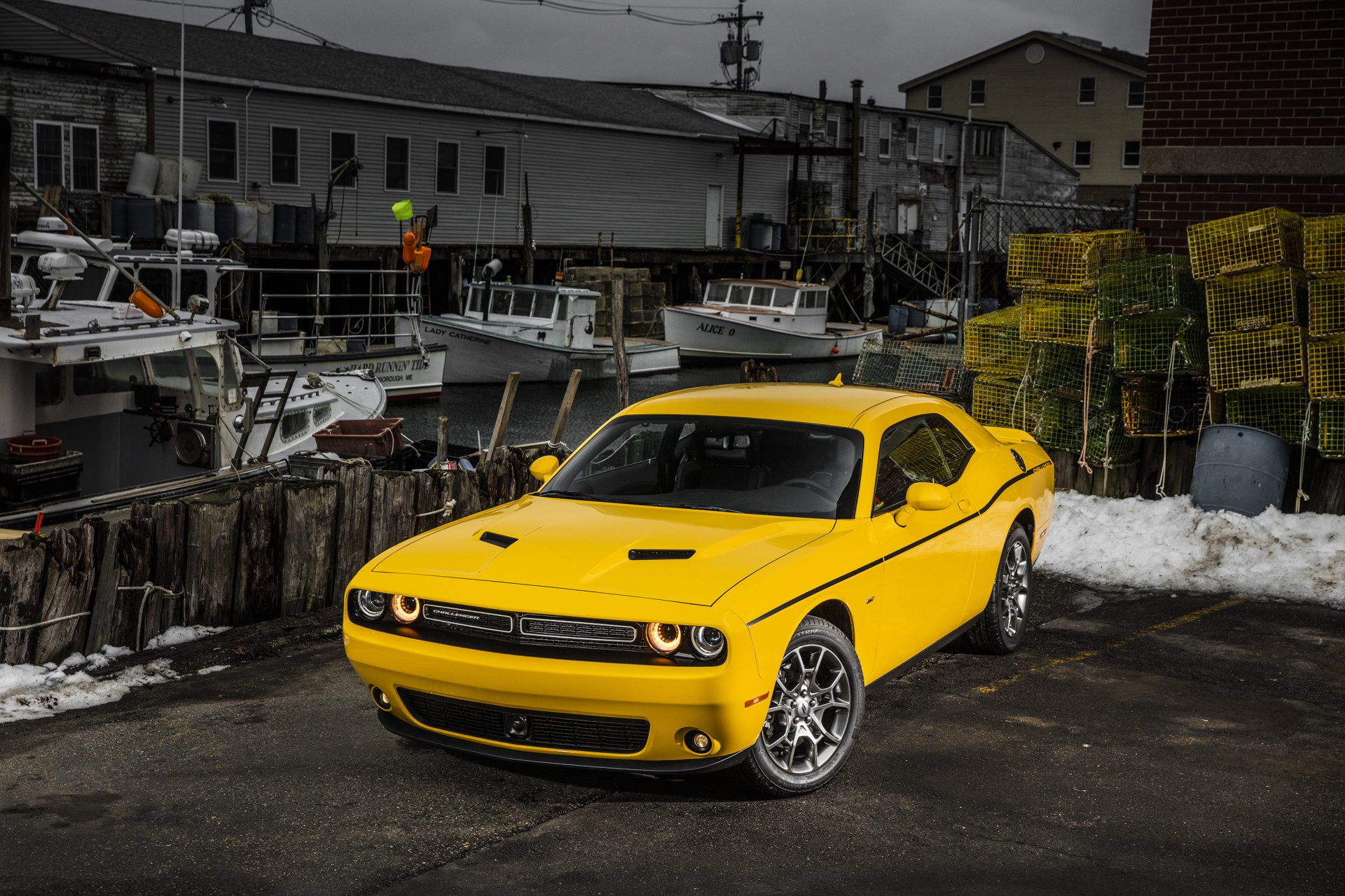 Yellow Dodge Challenger muscle car parked by fishing boats and lobster traps at a dock — 2K Quad HD PC desktop wallpaper/background