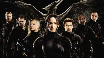 HD PC desktop wallpaper for The Hunger Games: Mockingjay - Part 1 showing Katniss Everdeen in black battle gear leading rebel fighters before a large mockingjay emblem.