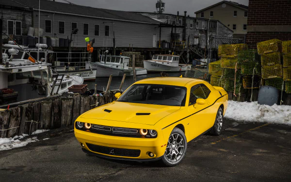 Yellow Dodge Challenger muscle car parked by fishing boats and lobster traps at a dock — 2K Quad HD PC desktop wallpaper/background