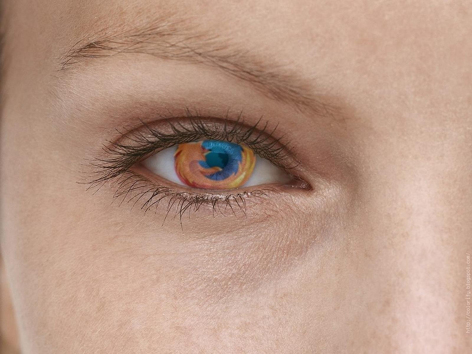 Close-up of a human eye with the Mozilla Firefox browser logo reflected on the iris, symbolizing internet technology and web browsing on an HD PC desktop wallpaper.