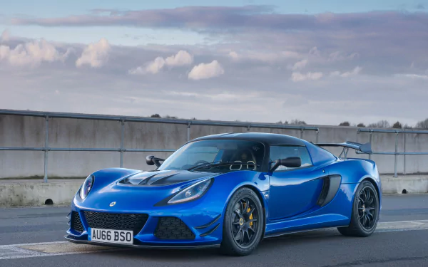 A sleek blue Lotus Exige supercar parked on a road, captured in 4K Ultra HD for a dynamic PC desktop wallpaper.