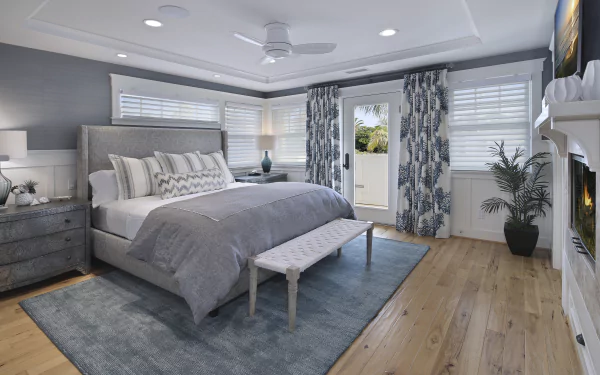 A modern bedroom with a large bed, bench, patterned curtains, gray walls, and wooden floor, captured in 4K Ultra HD as a PC desktop wallpaper background.