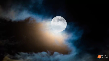 HD PC desktop wallpaper showing a bright full moon surrounded by dark and softly illuminated clouds against a deep night sky, showcasing nature’s nighttime beauty.