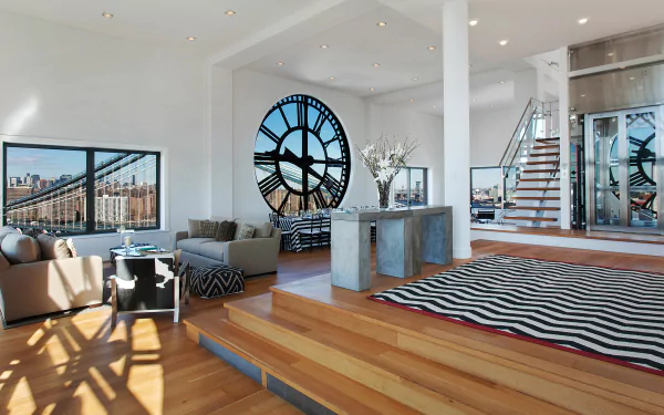 Spacious New York penthouse living room with a large man-made clock window, modern furnishings, and an open, sunlit layout.