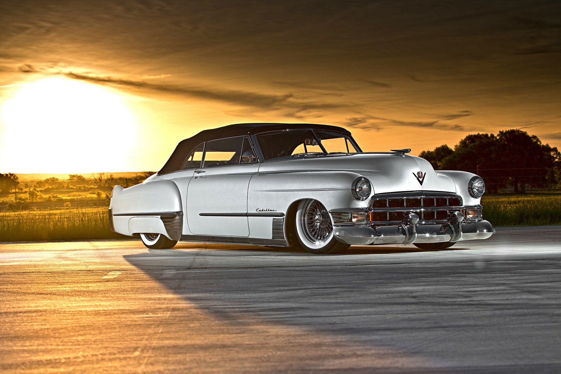 A luxury Cadillac Series 62 convertible lowrider hot rod showcased at sunset, captured in high definition as a sleek PC desktop wallpaper and background.