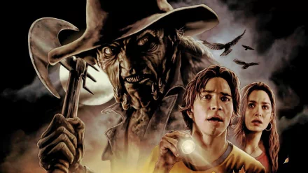 HD PC desktop wallpaper featuring a dark, menacing figure from the movie Jeepers Creepers looming behind two frightened young characters, set against a stormy, eerie backdrop.