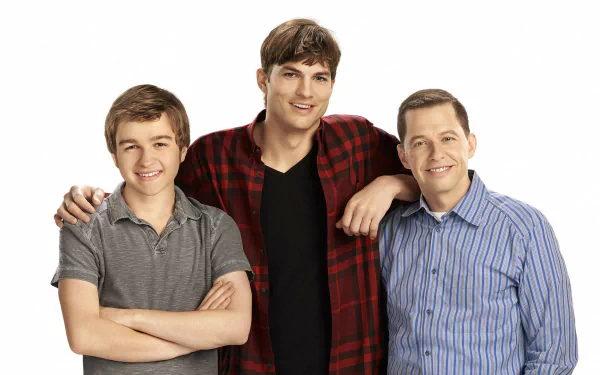 HD PC desktop wallpaper featuring the main cast of the TV show Two and a Half Men, showcasing three male characters smiling against a white background.