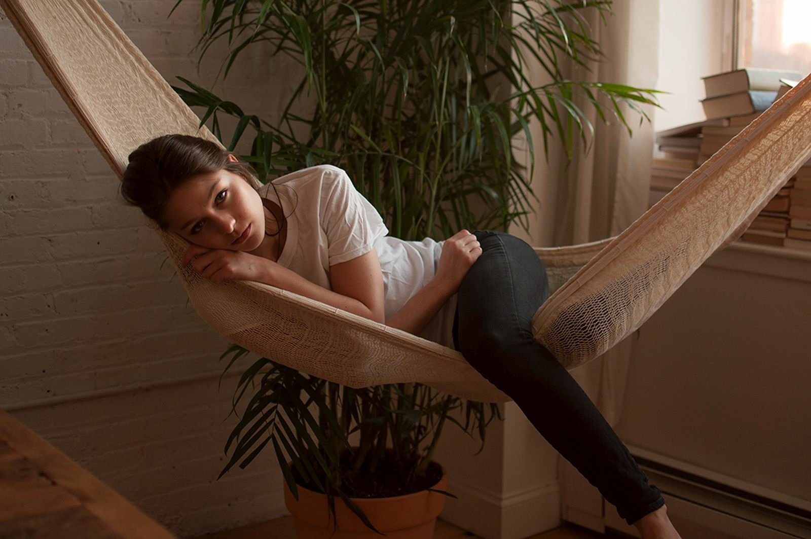 A serene HD desktop wallpaper featuring Melissa Benoist lounging in a hammock, surrounded by greenery and soft natural light, capturing a moment of relaxation.