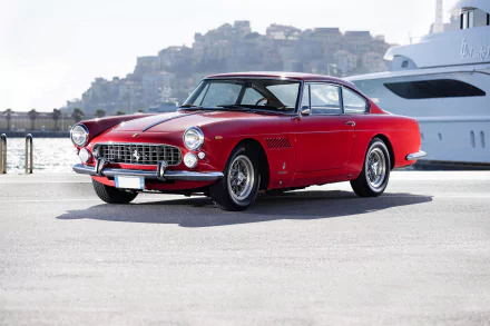 A classic red Ferrari 330 parked near a waterfront, captured in sharp 4K Ultra HD as a PC desktop wallpaper background.
