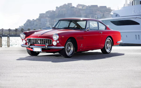 A classic red Ferrari 330 parked near a waterfront, captured in sharp 4K Ultra HD as a PC desktop wallpaper background.