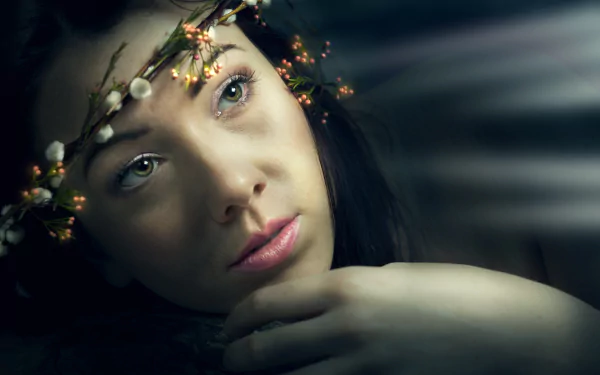 Close-up of a woman model with green eyes and pink lipstick wearing a delicate wreath, captured in 4K Ultra HD for a PC desktop wallpaper background.