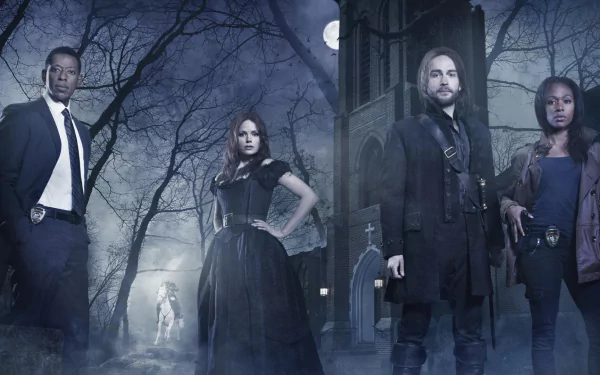 HD PC desktop wallpaper: Sleepy Hollow TV show cast posed in a moonlit, foggy graveyard outside a gothic church, Headless Horseman seen in the background.
