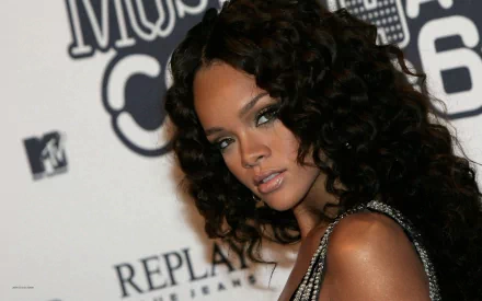 A striking HD desktop wallpaper featuring Rihanna, showcasing her glamorous style and captivating presence at a music event, creating a vibrant background for any screen.