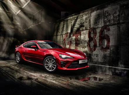 A red Toyota 86 sports car in a dimly lit, industrial setting, showcased in stunning 4K Ultra HD as a PC desktop wallpaper and background.
