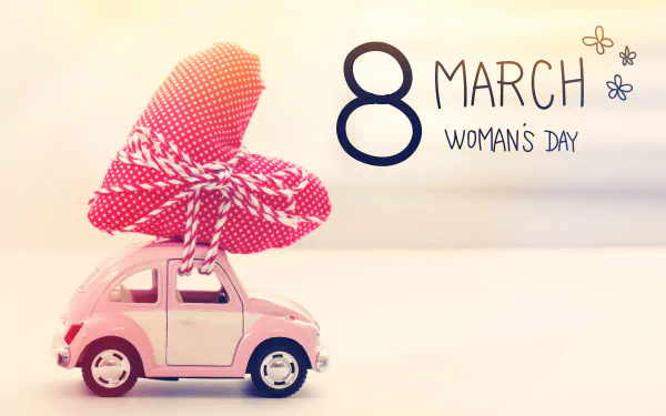 A pink toy car carrying a red heart tied with string, with 8 March Women's Day text, designed as a 4K Ultra HD PC desktop wallpaper celebrating the holiday.