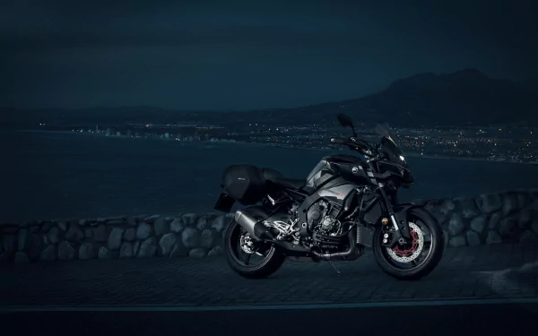 Night shot of a Yamaha MT-10 two-wheeled vehicle parked by a coastal road, rendered as a 4K Ultra HD PC desktop wallpaper/background.