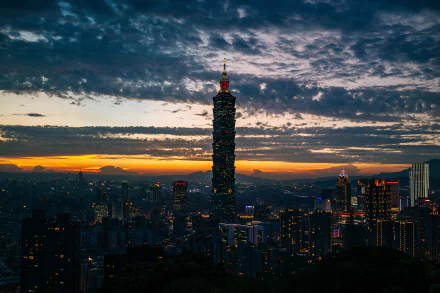 Taipei sunset cityscape with clouds and the Taipei 101 skyscraper rising above urban buildings — 4K Ultra HD PC desktop wallpaper and background of Taiwan's man-made skyline.