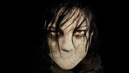 HD PC desktop wallpaper featuring a haunting close-up of a character from the movie Silent Hill: Revelation with intense eyes and a dark, eerie atmosphere.