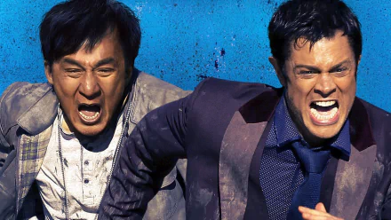HD desktop wallpaper featuring Jackie Chan and a co-star from the 2016 movie Skiptrace, directed by Renny Harlin. Both characters are captured in an intense scene with vivid expressions against a blue background.