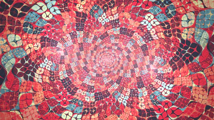 Vibrant HD desktop wallpaper featuring an abstract pattern with a mosaic of orange and red colors, radiating from a central point.