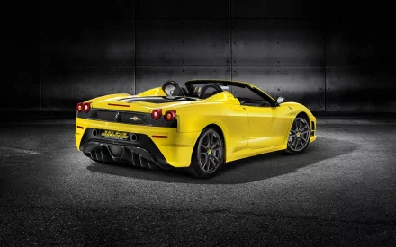 Yellow Ferrari Scuderia Spider 16M sports car showcased against a dark industrial background, featured as an HD PC desktop wallpaper and background.