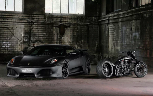 HD desktop wallpaper featuring a sleek black Ferrari parked next to a custom motorcycle in an industrial building with brick walls and large windows.