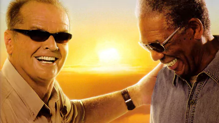 HD desktop wallpaper featuring Jack Nicholson and Morgan Freeman sharing a joyful moment from the movie The Bucket List against a warm sunset background.