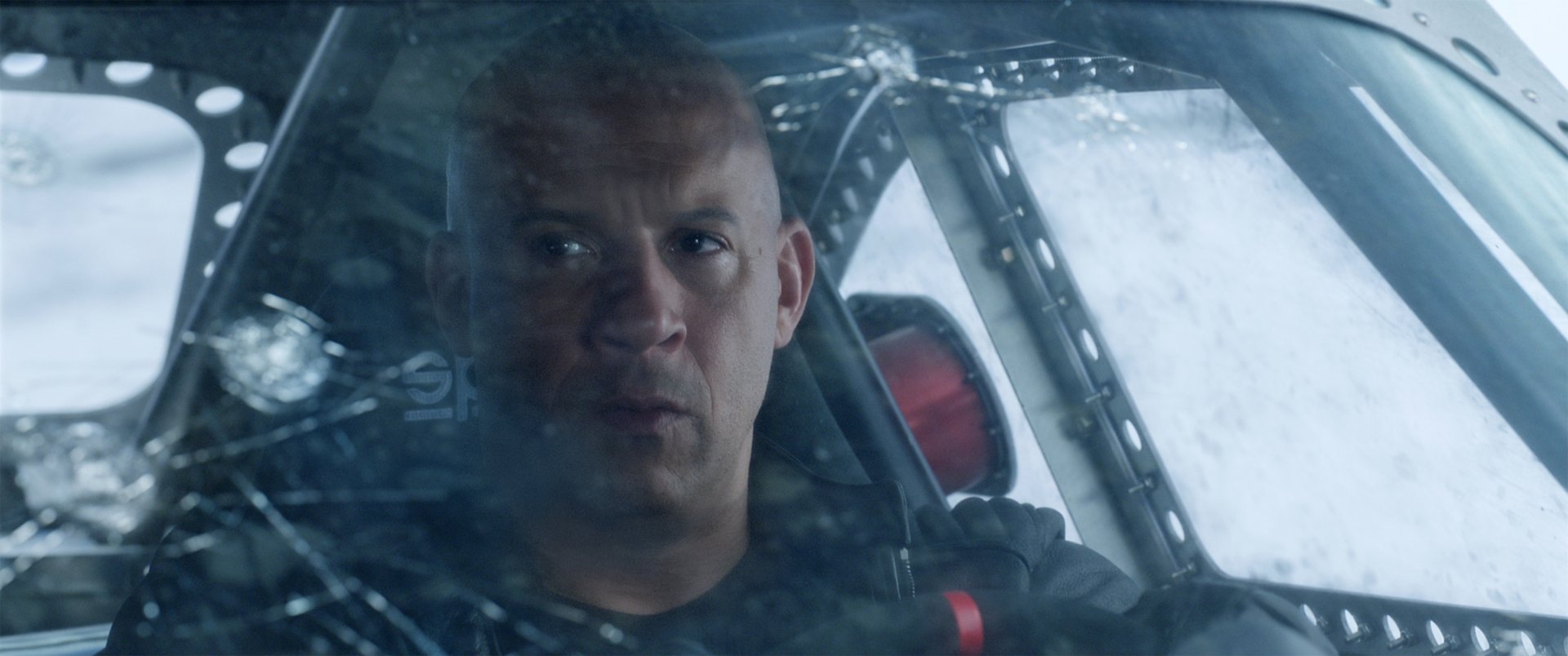 HD desktop wallpaper featuring Vin Diesel as Dominic Toretto from the movie The Fate of The Furious, showing him inside a vehicle with a focused expression.