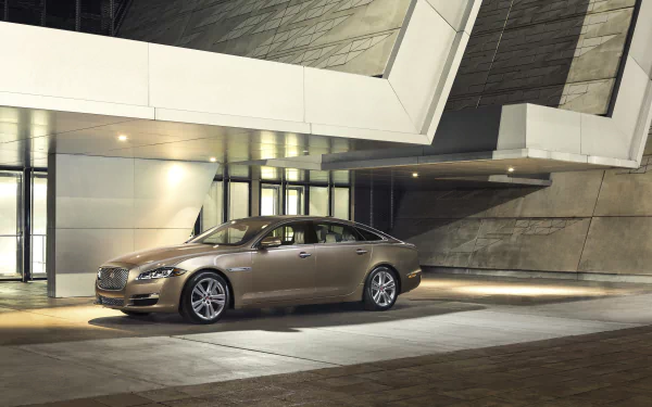 Silver Jaguar XJ parked in front of a modern architectural building, captured in a sharp 4K Ultra HD desktop wallpaper image.