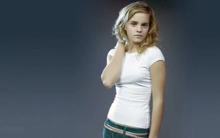 Emma Watson poses in a casual white t-shirt against a softly blurred background, captured in this HD desktop wallpaper. A striking and elegant celebrity image.