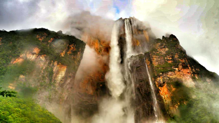 HD wallpaper featuring the majestic Angel Falls cascading down a rugged cliff in a misty, lush natural setting.